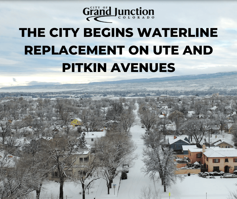 An ariel view of a street during winter with mountains in the background. Text on graphic.