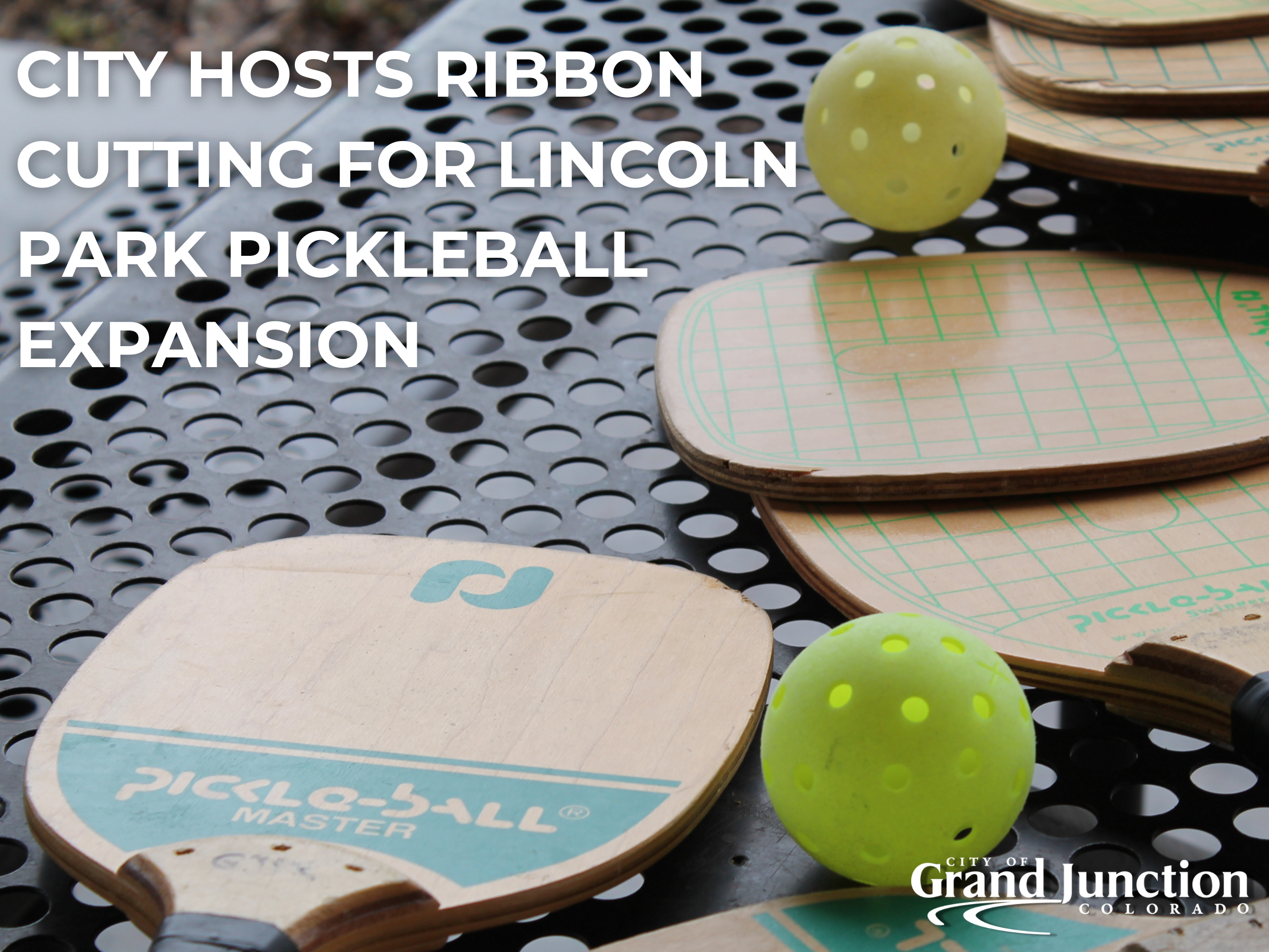 Pickleball paddles laying on a table outside on a rainy day