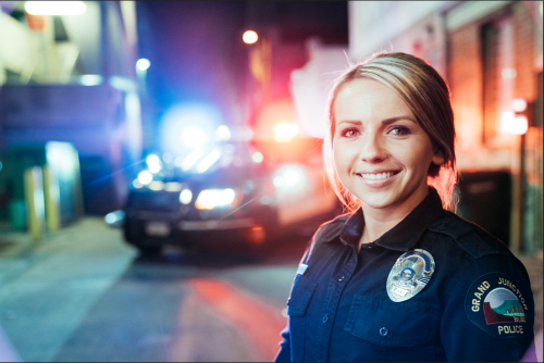 Police officer standing in front of a police car