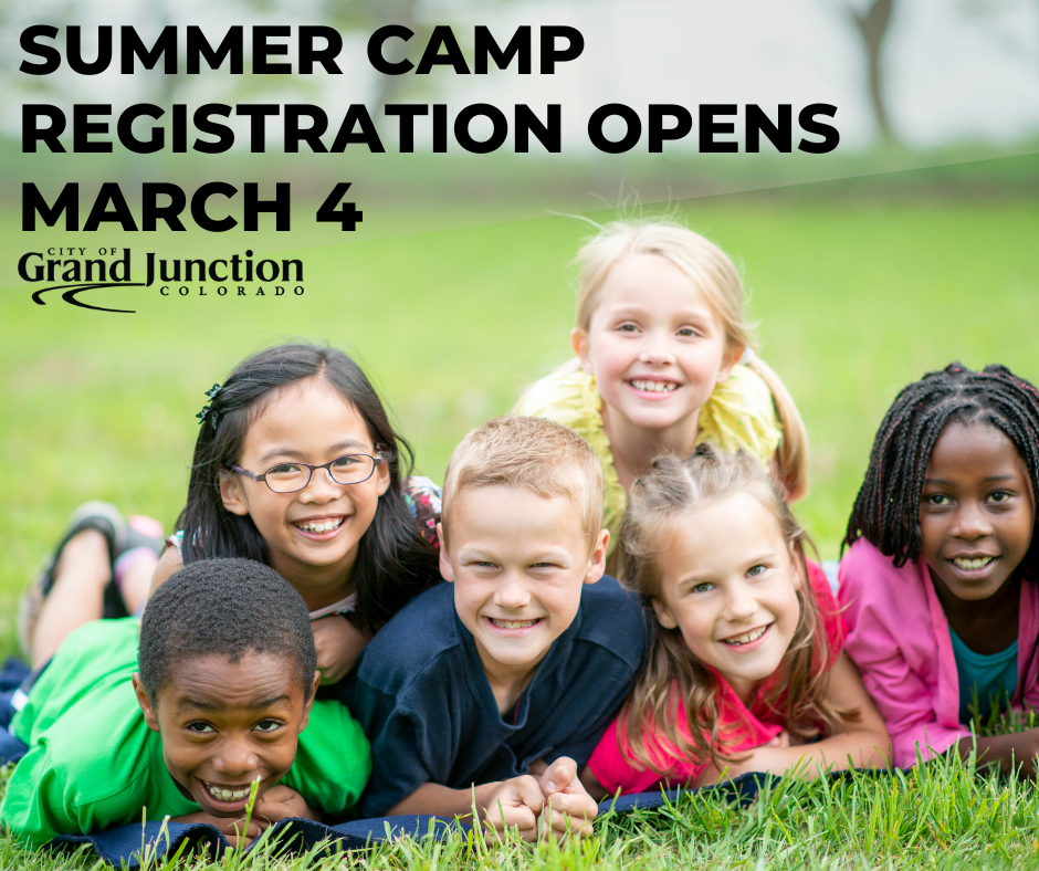 Group of children smiling, sitting in the grass and text on the graphic