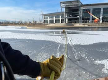 Hands pulling in rope for ice rescue