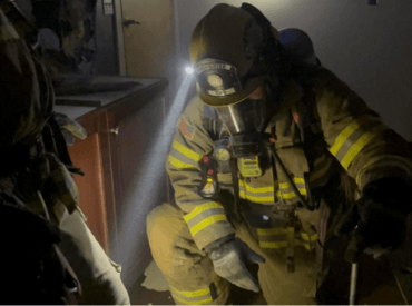Firefighter in full gear including gas mask