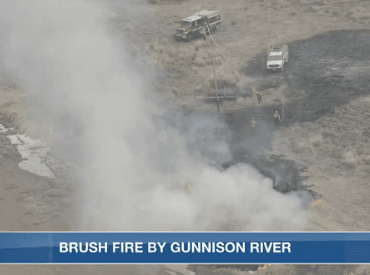 arial view of fire department putting out a fire by river