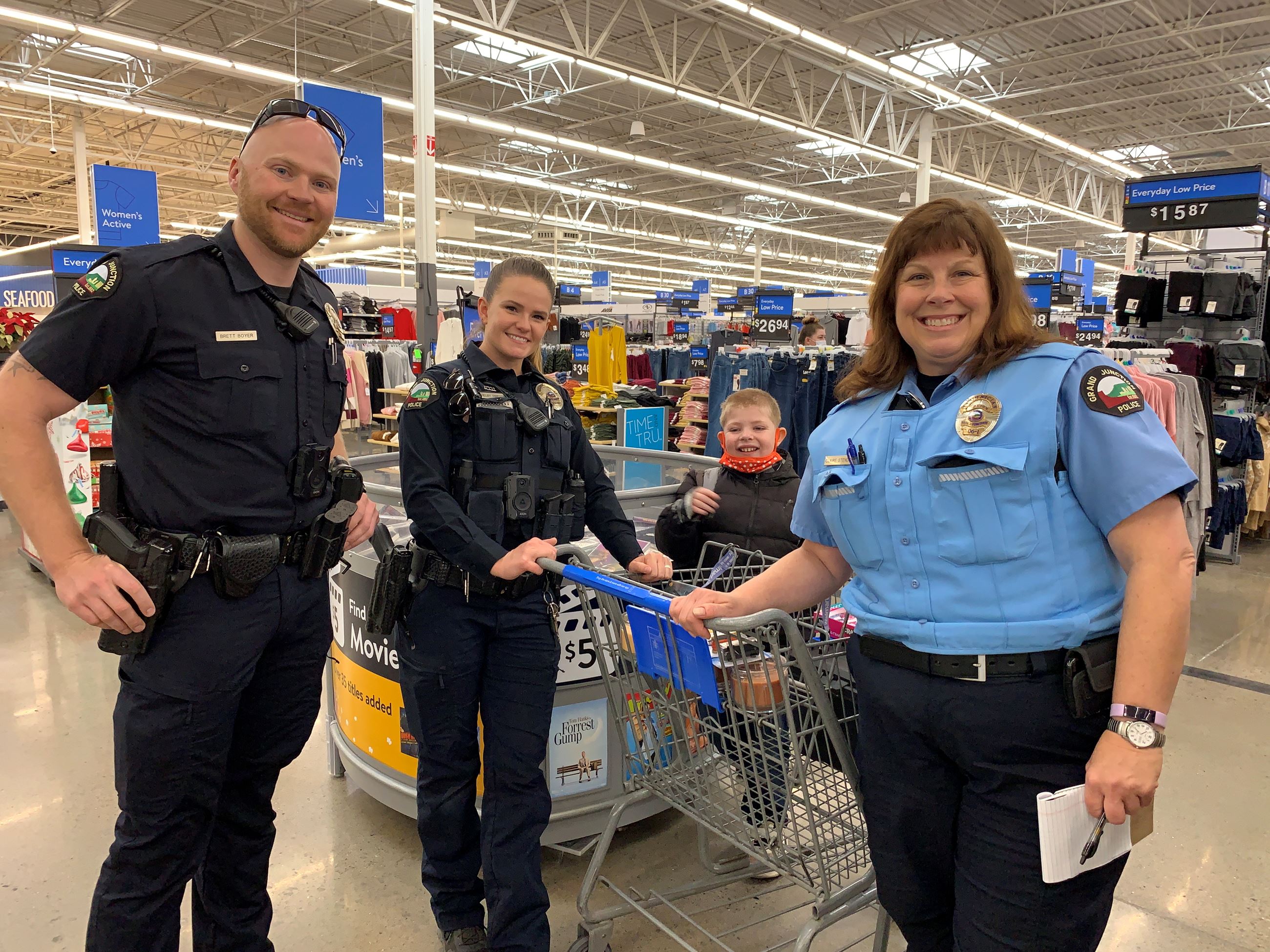 three police officers shopping with a student