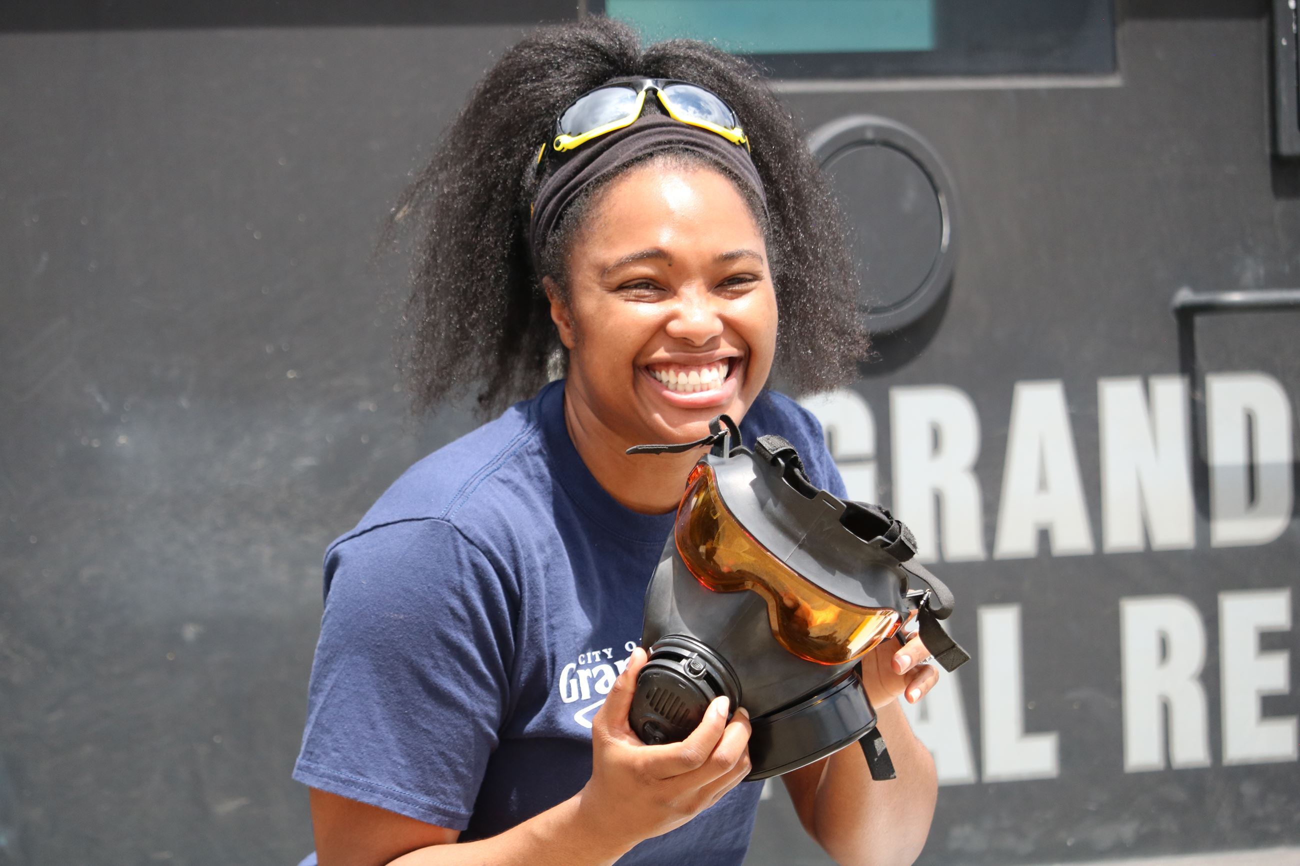 Woman putting on a gas mask