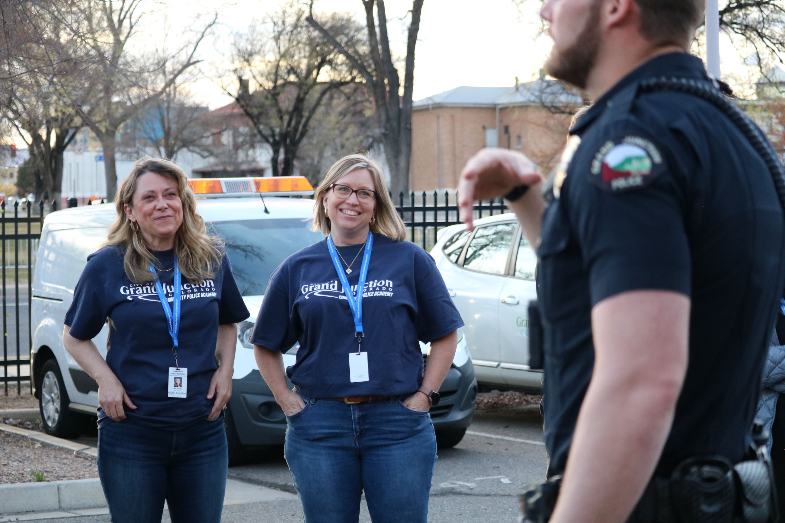 Community Police Academy Members listening to officer